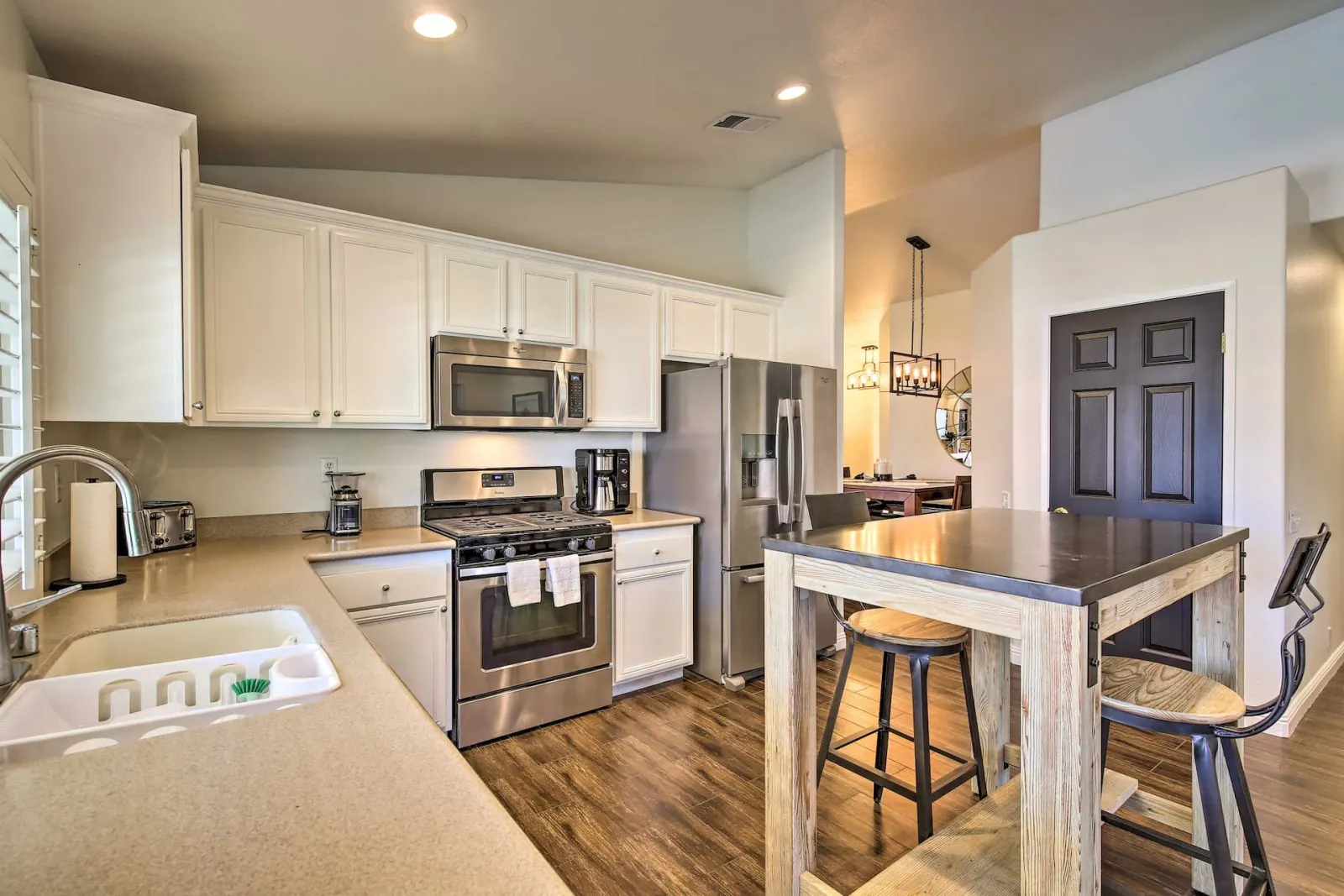 Kitchen with stainless appliances and a breakfast bar